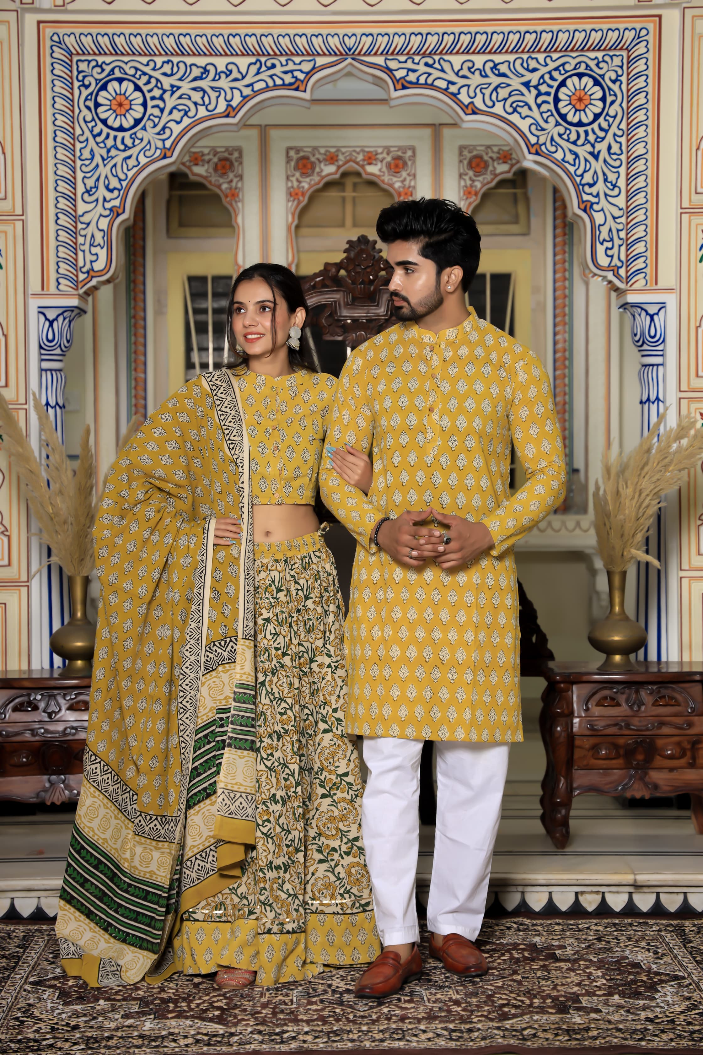 Majestic Yellow Bagru Hand Printed Couple Set – Vibrant Chaniya Choli with Multicolored flowerd Skirt & Elegant Mulmul Dupatta | Matching Regal Men’s Kurta with Classic White Payzama