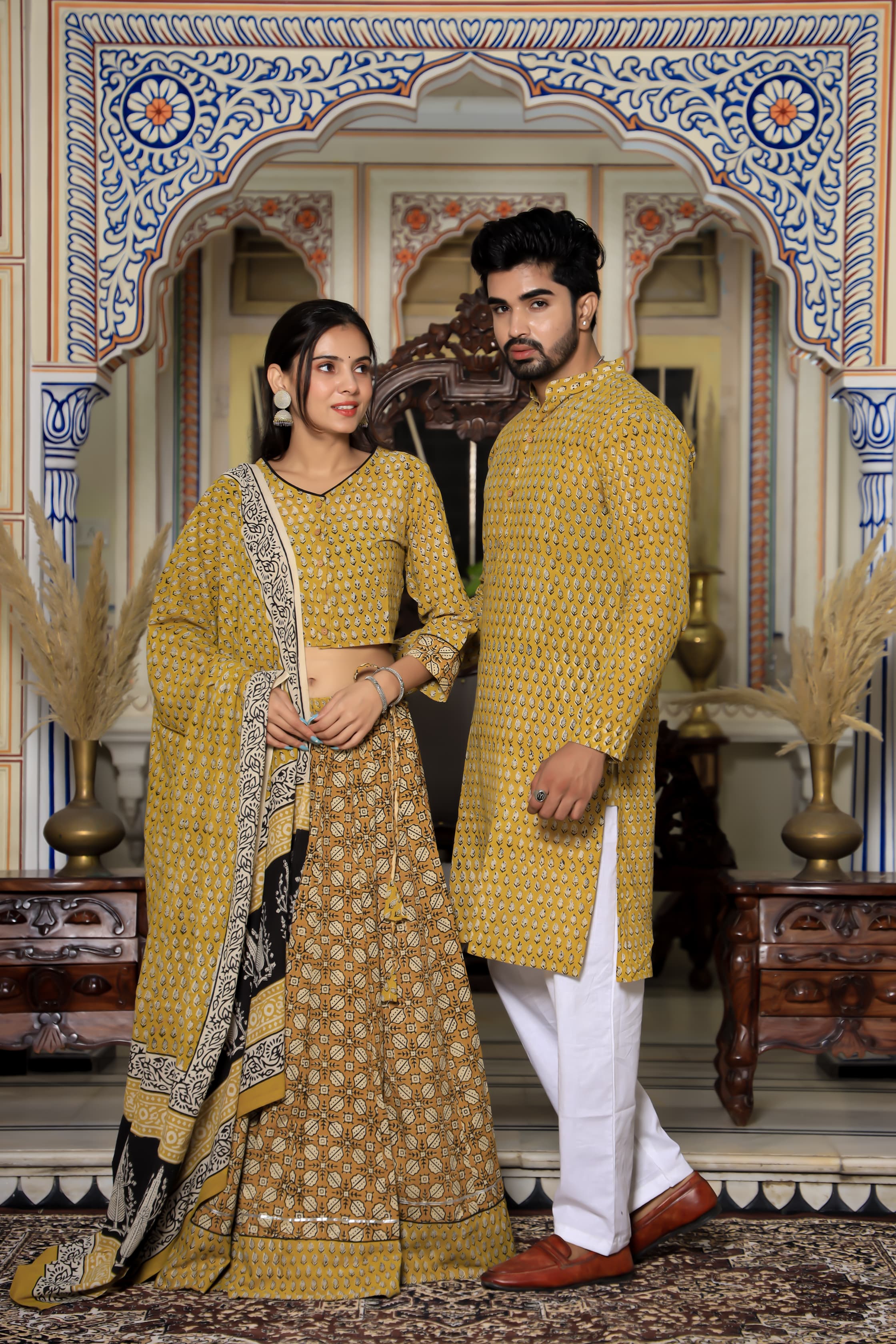 Majestic Yellow Bagru Hand Printed Couple Set – Vibrant Chaniya Choli with Multicolored flowerd Skirt & Elegant Mulmul Dupatta | Matching Regal Men’s Kurta with Classic White Payzama