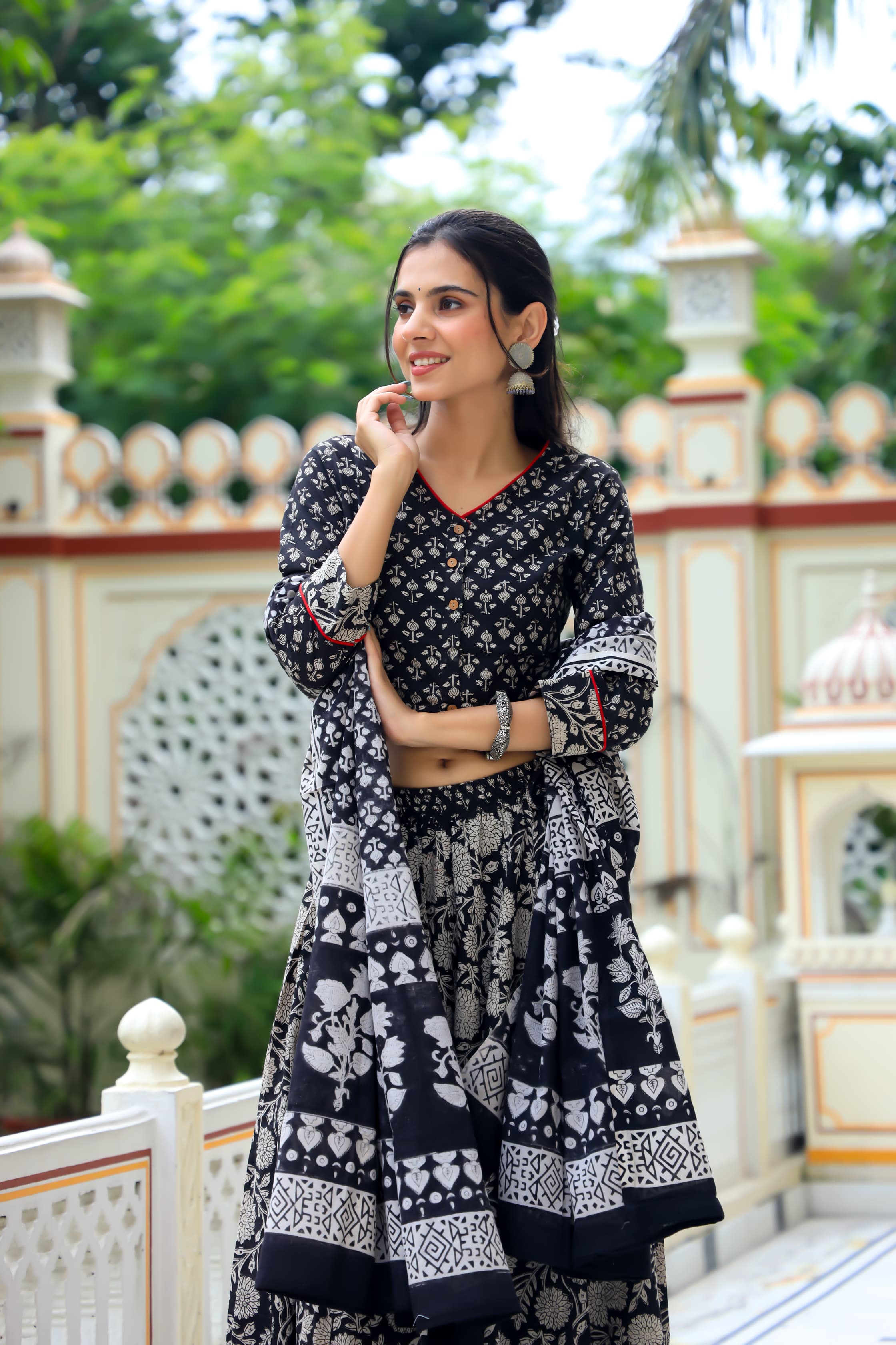 Majestic Black Bagru Hand Printed Couple Set – Vibrant Chaniya Choli with Multicolored flowerd Skirt & Elegant Mulmul Dupatta | Matching Regal Men’s Kurta with Classic White Payzama