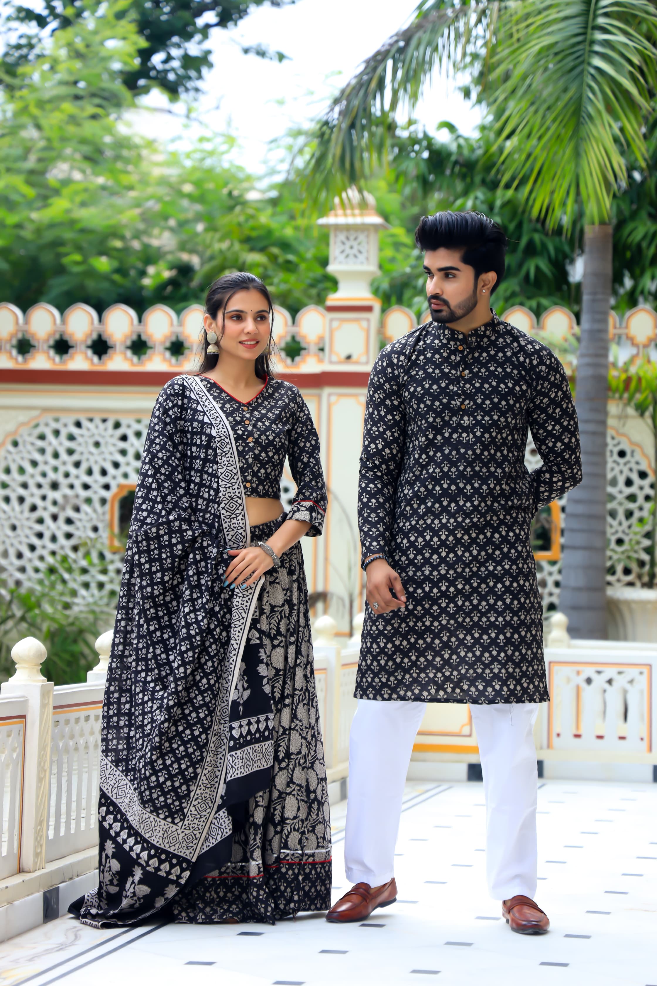 Majestic Black Bagru Hand Printed Couple Set – Vibrant Chaniya Choli with Multicolored flowerd Skirt & Elegant Mulmul Dupatta | Matching Regal Men’s Kurta with Classic White Payzama