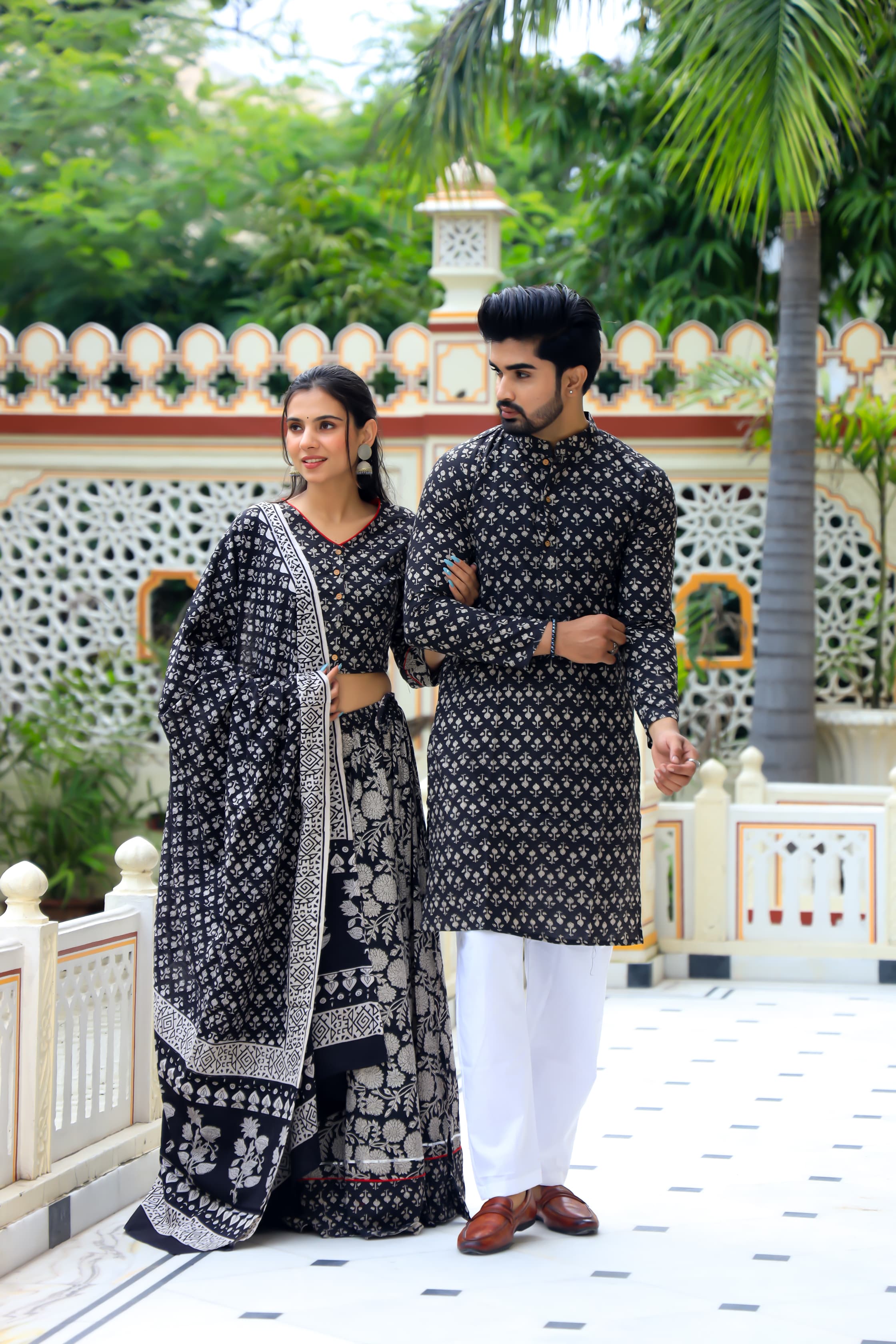 Majestic Black Bagru Hand Printed Couple Set – Vibrant Chaniya Choli with Multicolored flowerd Skirt & Elegant Mulmul Dupatta | Matching Regal Men’s Kurta with Classic White Payzama